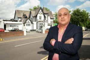 Balvinder Sambhi stands outside Rainbow Casino with his arms crossed.