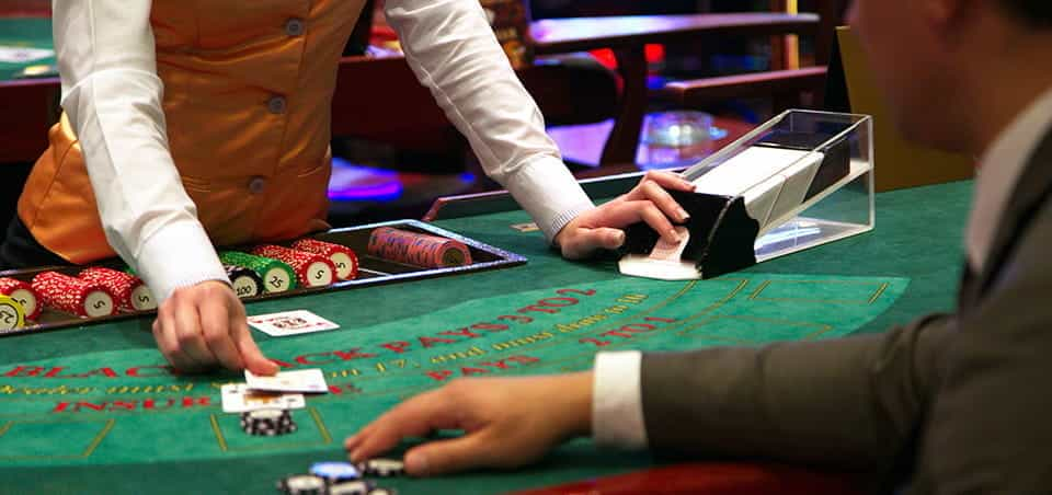 A croupier dealing a hand of blackjack.