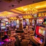 A casino floor covered in colorful, brightly lit slot machines.