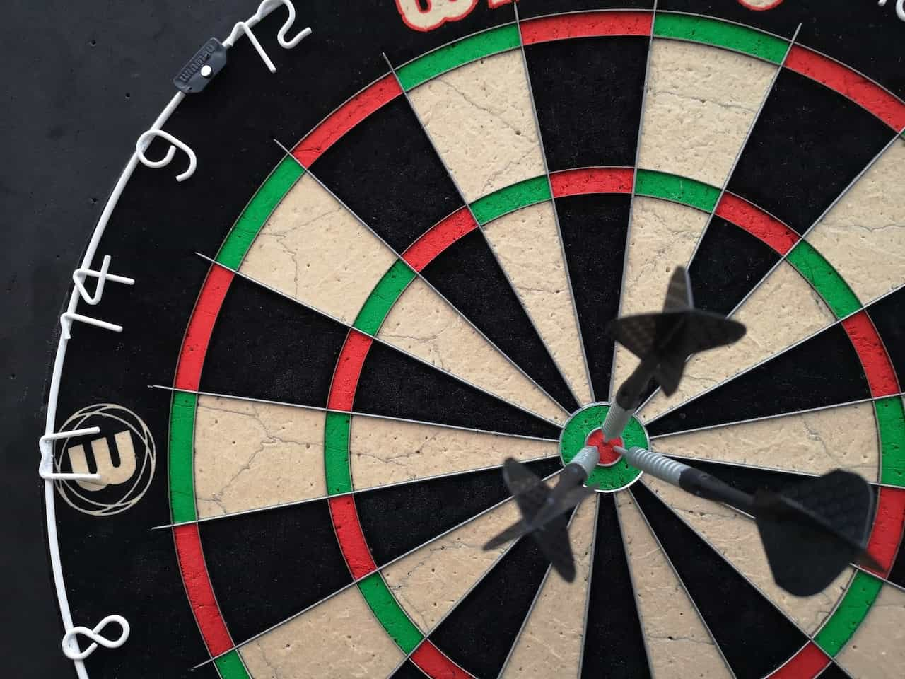 A dartboard with three darts.