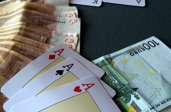 Three Aces sat along cash Euro notes.