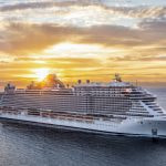 A massive cruise ship in the ocean pictured from above.